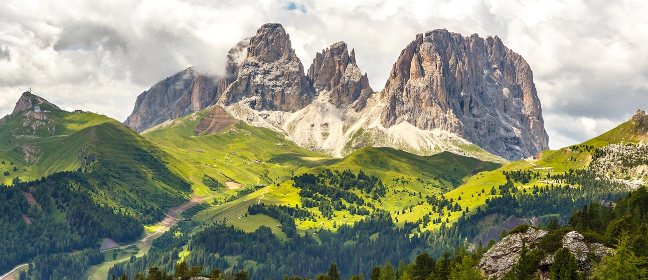 The Dolomites surrounded by green meadows and woods